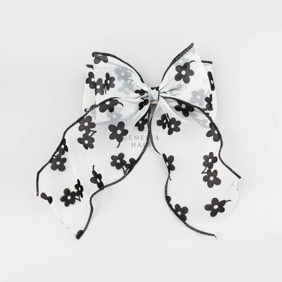 Mesh & Velvet Floral Hair Bow Clip featuring a sheer white fabric adorned with black velvet flowers and a black-trimmed edge