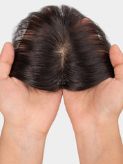 Top view of mini topper showing natural hair parting and hand-held lace base