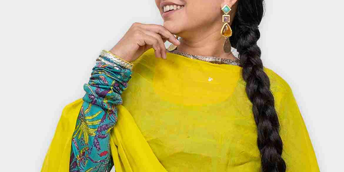 Woman wearing long braid ponytail extension styled with traditional outfit