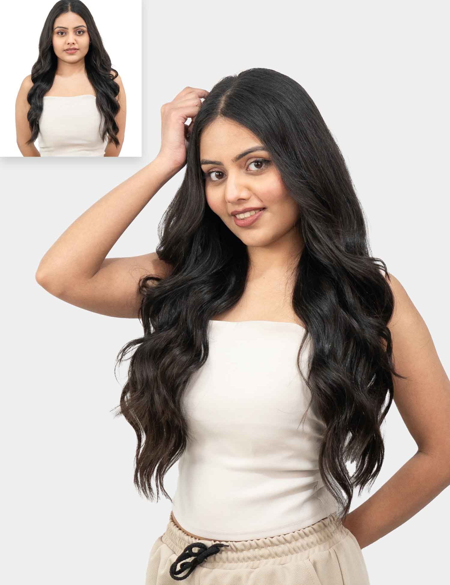 A woman showcasing wavy clip-in hair extensions that provide extra volume and length, with a natural wavy texture.