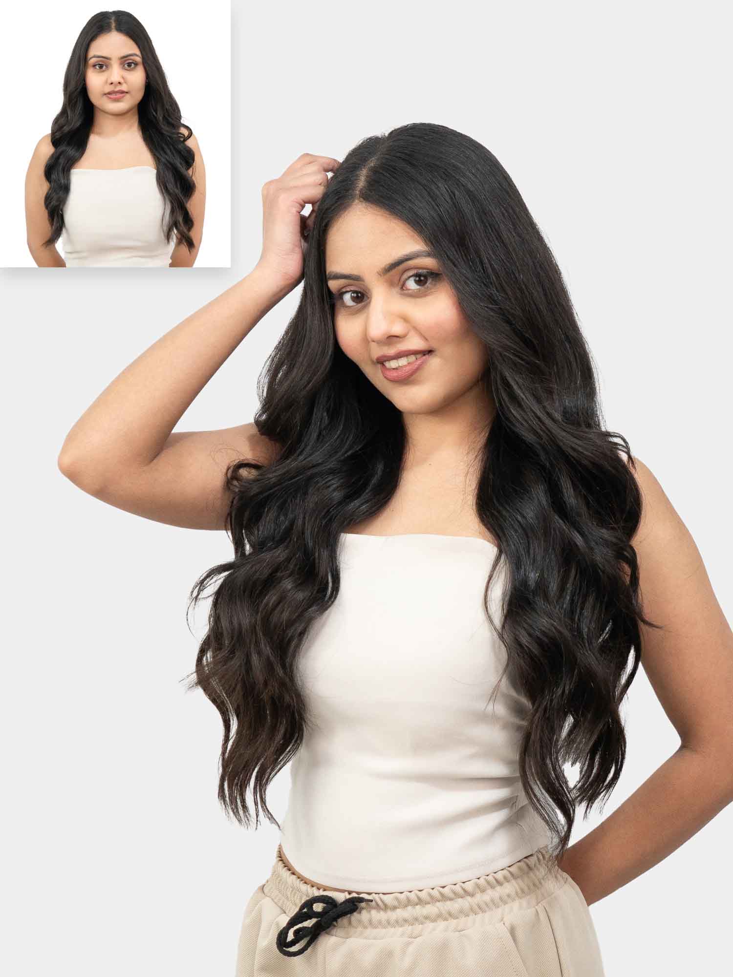 A woman showcasing wavy clip-in hair extensions that provide extra volume and length, with a natural wavy texture.