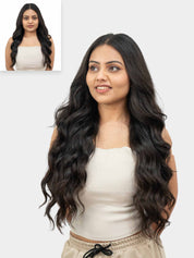 A woman with long wavy hair wearing a white top, with an inset picture showing her face with shorter hair.