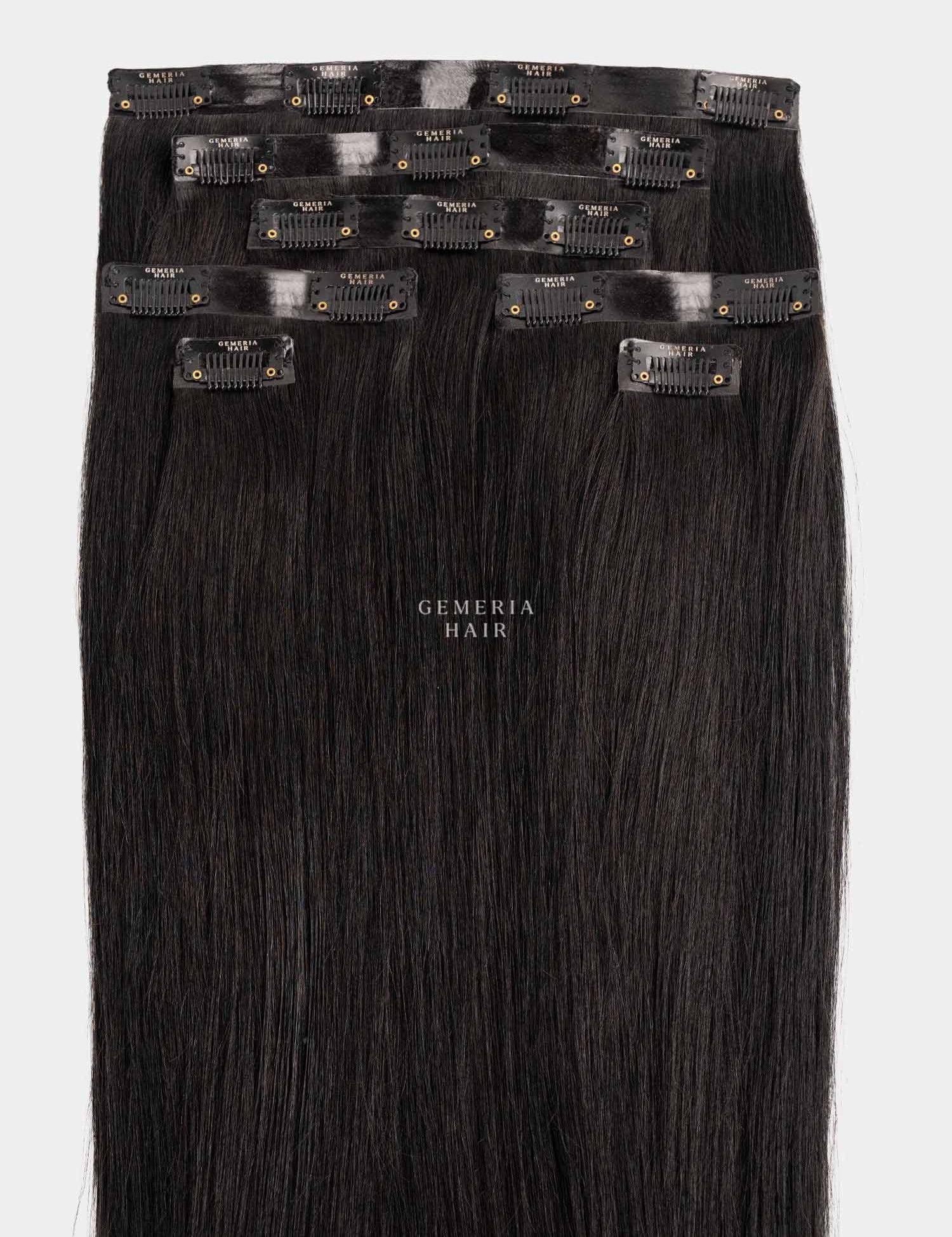 Set of black seamless clip-in hair extensions with clips on a white background, featuring the brand 'Gemeria Hair'.