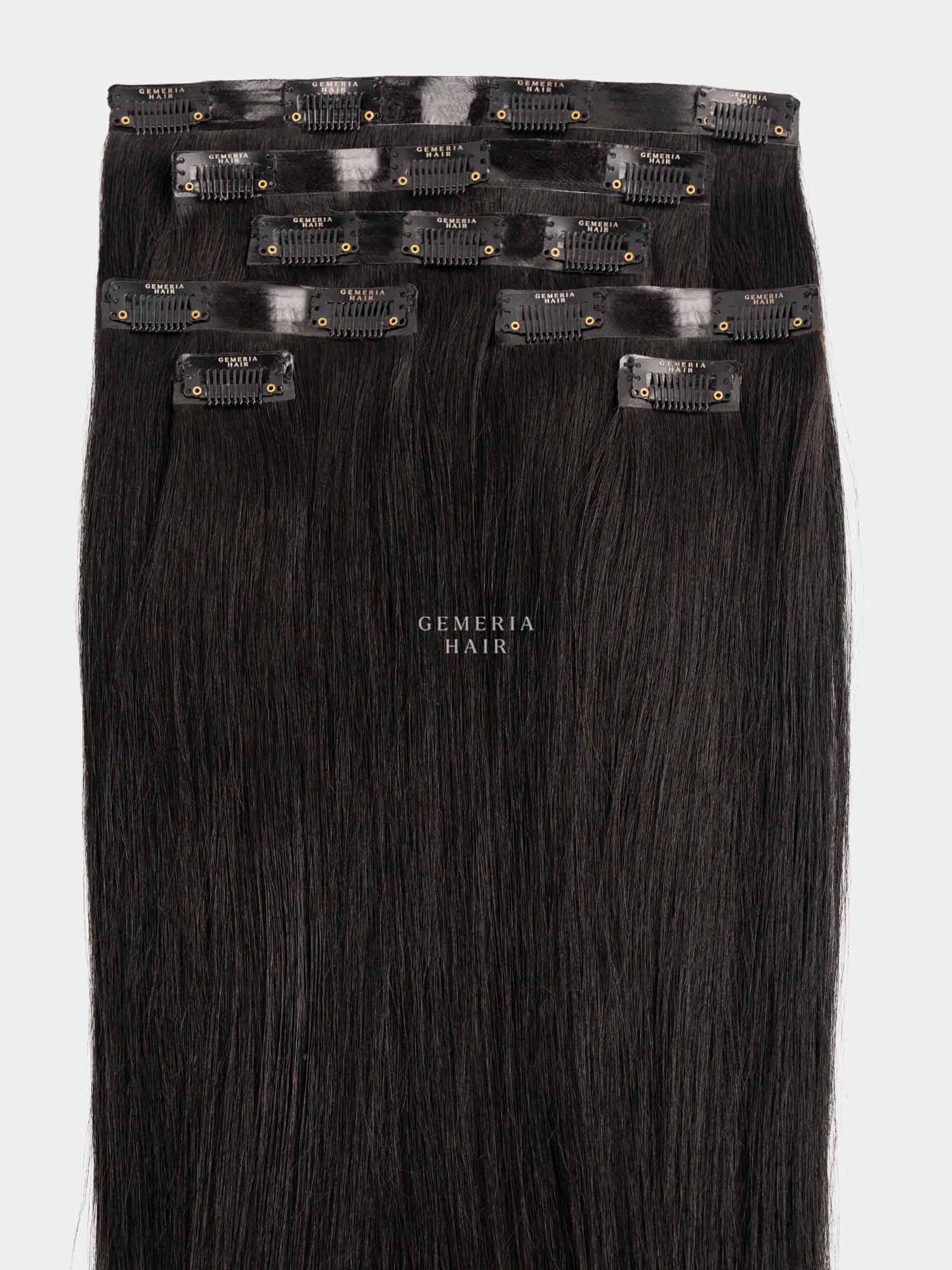 Set of black seamless clip-in hair extensions with clips on a white background, featuring the brand 'Gemeria Hair'.