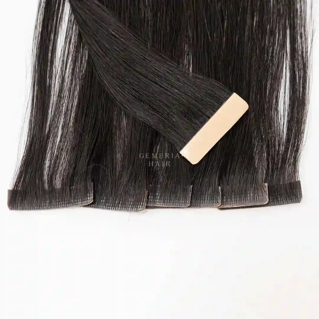 Gemeria Hair premium black permanent hair extensions with beige tape, professional salon quality installation